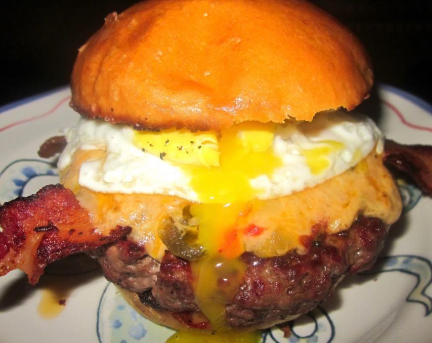 Over Easy Burger with French Fries · Fried egg, bacon and cheddar cheese. Please specify temperature.