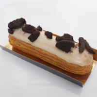 Eclair - Cookies & Cream · Cookies & cream pastry cream with vanilla glaze, topped with Oreos.