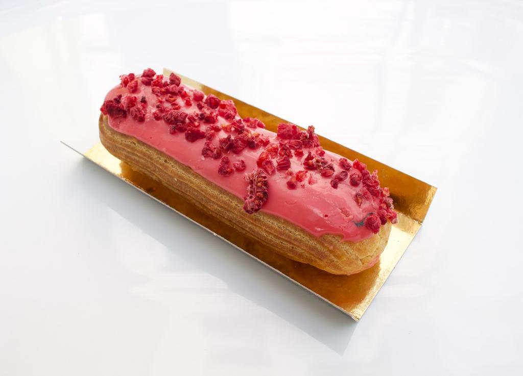 Eclair - Raspberry · Raspberry pastry cream and glaze with dried raspberry pieces.