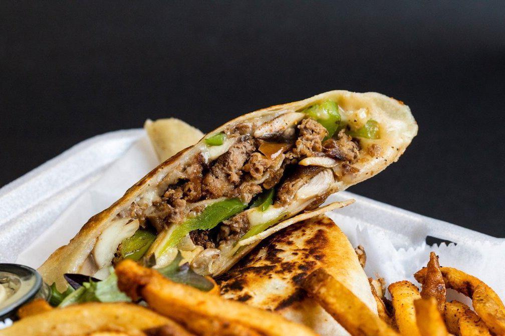 Philly Steak Wrap · Beef sirloin sautéed with our house seasoning., onions, mushrooms  green peppers, and Worcestershire sauce. Wrapped with mozzarella cheese and grilled in a flour tortilla . Mustard Aioli sauce on the side. Served with our hand-cut seasoned fries.