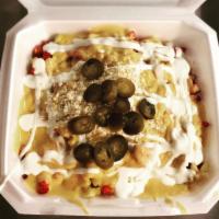 Nachos · Chips with cheese and a variety of toppings.