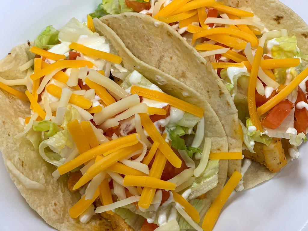 Chicken Tacos · Three Grilled Chicken Tacos with Lettuce, Monterey Jack & Cheddar cheese & Sour Cream served in flour tortillas.
