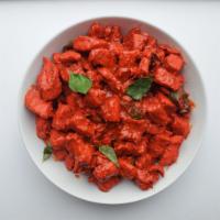 Chicken 65 · Chicken cooked in South Indian style with whole red chilies and curry leaves.