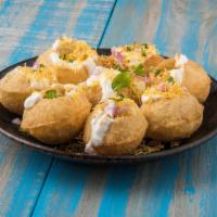 Dahi Puri · Flattened puris serve as the base with topping of potatoes, chutneys and garnished with sev.
