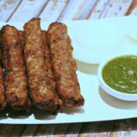 Lamb Seekh Kabab · Minced lamb mixed with onions, chilies and mint rolled over a skewer.