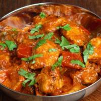 Chicken Curry · Chicken cooked in fresh onion, ginger, garlic and tomatoes with herbs and spices. Comes with...