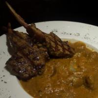 Lamb Chop Korma · Tender lamb chops cooked in a spiced creamy sauce. Comes with basmati rice on the side.