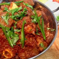 Bhuna Goat Masala · Goat cooked with onion, garlic and bell peppers. Comes with basmati rice on the side.