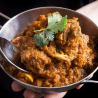 Karahi Goat · Goat with spiced curry, bell pepper, onion, tomato and ginger. Comes with basmati rice on th...