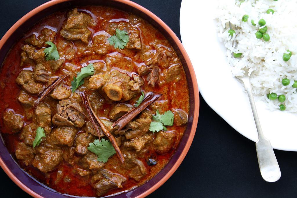 Handi Goat Curry · Tender goat cooked in Handi-style curry sauce. Comes with basmati rice on the side.