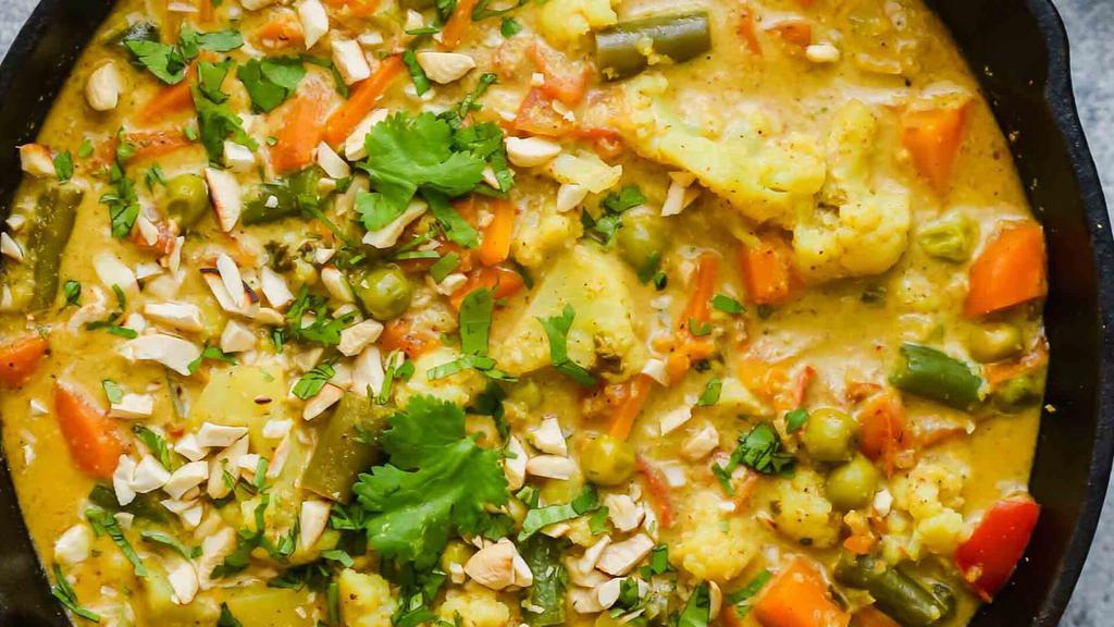 Navaratan Korma · A melange of vegetables cooked in a mild sauce. Served with basmati rice on side.