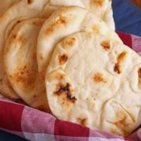 Naan · Bread made with white flour baked in a tandoor