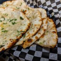 Garlic Butter Naan · Refined flour bread topped with roasted garlic and cilantro.