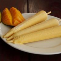 Mango Kulfi · Homemade mango ice cream served with fresh mango and arrowroot saffron threads.