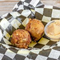 Boudin Balls · Pork sausage made with rice and seasoning, stuffed with jack cheese. Breaded and fried. Serv...