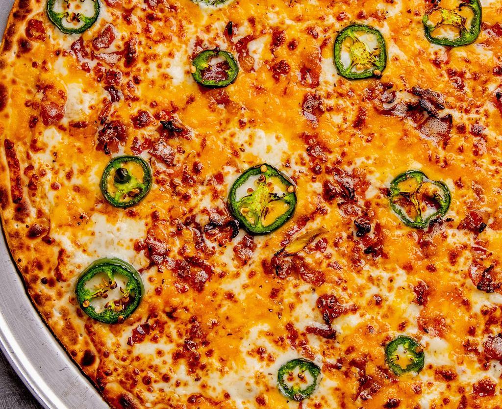 Jalapeño Popper Pizza · Can you Handle the Heat? Our Jalapeño Popper Pizza is topped with Freshly Sliced Jalapeño Peppers, Hardwood Smoked Bacon, Shredded Cheddar Cheese, and Whipped Cream Cheese.