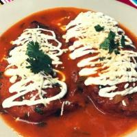 Chiles Rellenos · Stuffed peppers served with rice and beans, and tortillas or bread.