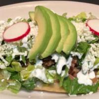 Huarache de Pollo · Chicken. Hand Made Oval Tortilla with choice of meat, avocado, lettuce, refried beans, sour ...