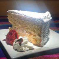 Pastel de Tres Leches · Three Milks Cake filled with whipped cream and nuts.
