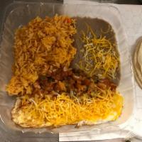 Huevos Rancheros Breakfast Plate · Two eggs with cheese on top, Mexican Salsa, Rice and beans with cheese, and tortillas on the...