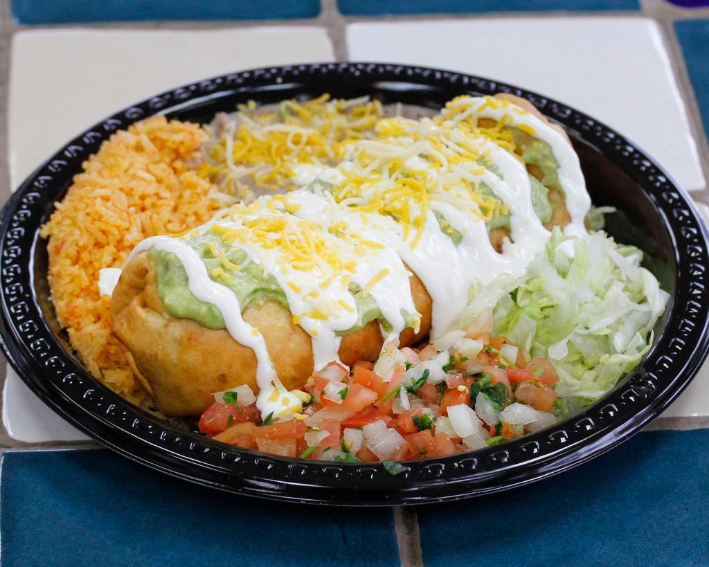 Special #4. Chimichanga · Your choice of shredded chicken, or ground beef, or shredded beef cooked with veggies. Beans and cheese inside. With guacamole, sour cream, and cheese on top. Lettuce and Pico de Gallo on the side. (Pictured with beans and rice on the side as well +$2.99)