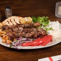 Pork Kebab Platter · 3 pork skewers, tzatziki, spicy feta, tomatoes, onions, lettuce, and french fries or rice.