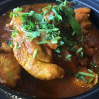 Dhabba Chicken Curry · Traditional combination of Indian spices cooked in a robust tomato sauce