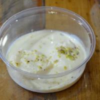 Rasmalai · Sweet milk patties, dipped in cardamom flavored milk with pistachio.