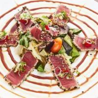 Ahi Tuna Appetizer · Served fresh with sesame seeds and mixed greens.