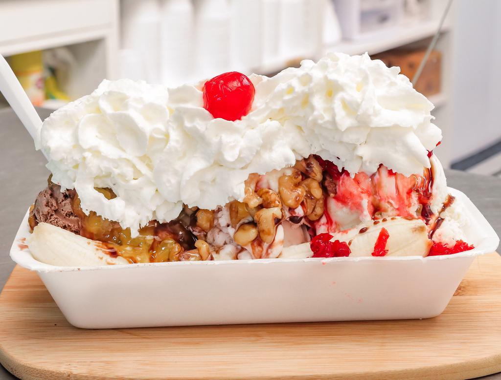 Traditional Banana Split · Three large scoops of ice cream, banana, chocolate syrup, crushed pineapples, crushed cherries and wet walnuts, topped with whipped cream and a cherry. 