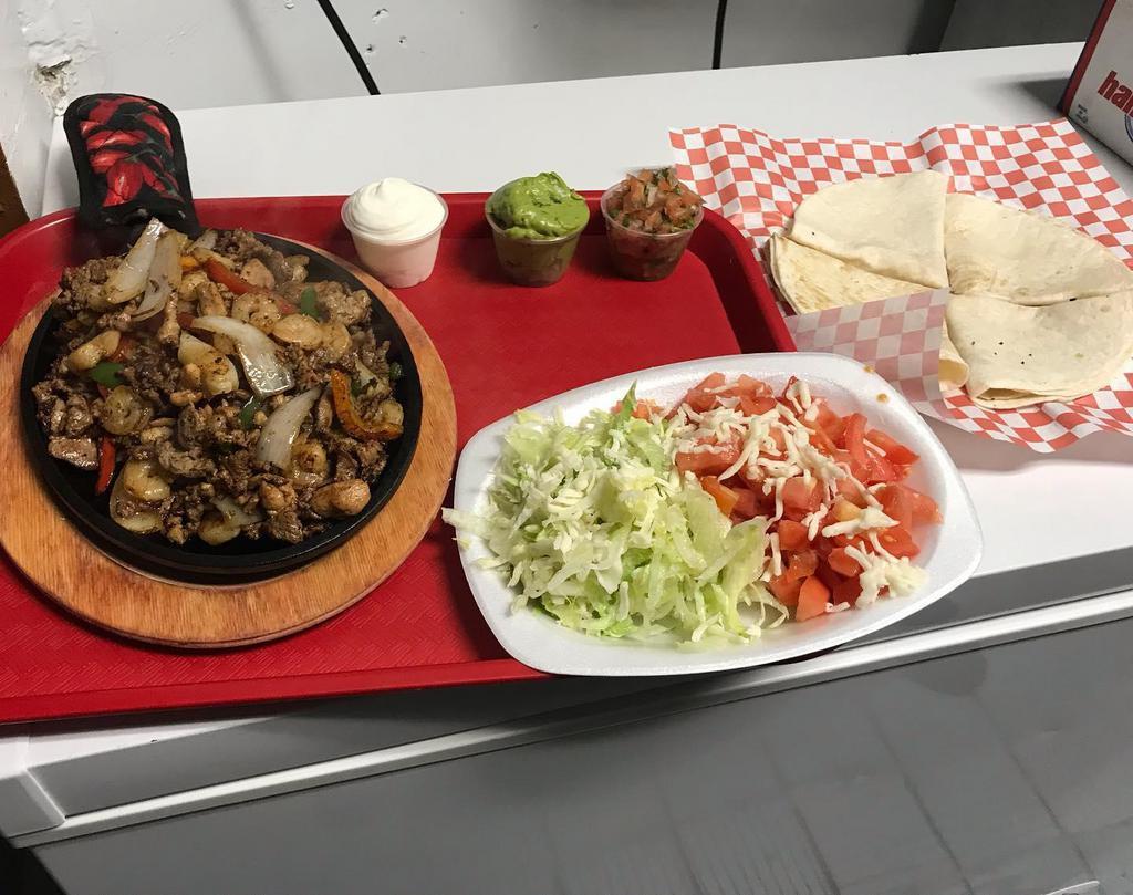Fajitas  · Choice of 4 flour tortilla or corn tortillas, sides of sour cream, guacamole, Spanish rice, Refried beans, pico de gallo, lettuce, tomatoes on the side, served with grilled peppers and onions.  