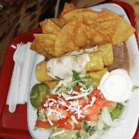 Flautas  · 3 rolled corn tortillas, suizo cheese, lettuce, tomatoes, refried beans, sour cream, Spanish...