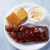 1/2 Rack of Ribs Plate · Served with 2 sides and you pick, our dry-rubbed ribs dipped in our house rib sauce or the s...