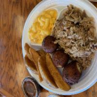 Pulled Pork Plate · Served with a Bun or 2 hushpuppies, 2 sides and sauce on the side.
