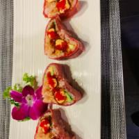 Sweet Heart Roll · Spicy tuna and avocado wrapped in soy paper, topped with tuna and chefs special sauce, red t...