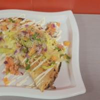 Quesadilla · Homade tortilla lettuce tomato chihuahua cheese sour cream cotija cheese and guacamole 