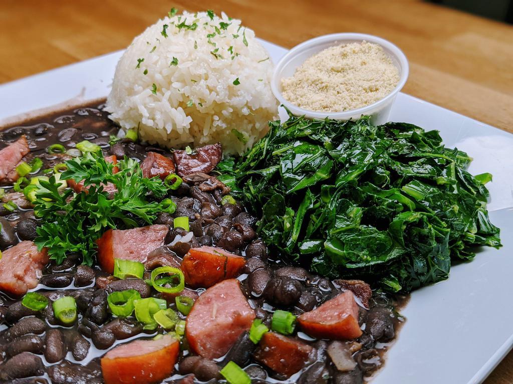 Rice and Beans (Feijoada) · This National Brazilian dish is now available for everyone to give it a try! Black bean stew with kielbasa sausage, bacon, pork, onions, garlic and black pepper, served with rice, collard greens and farofa (roasted cassava flour with herbs seasoning).

