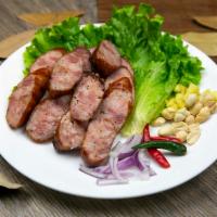 Isaan Sausage  · Northern style sour pork sausage, fresh ginger, peanuts, Thai chili & shallots