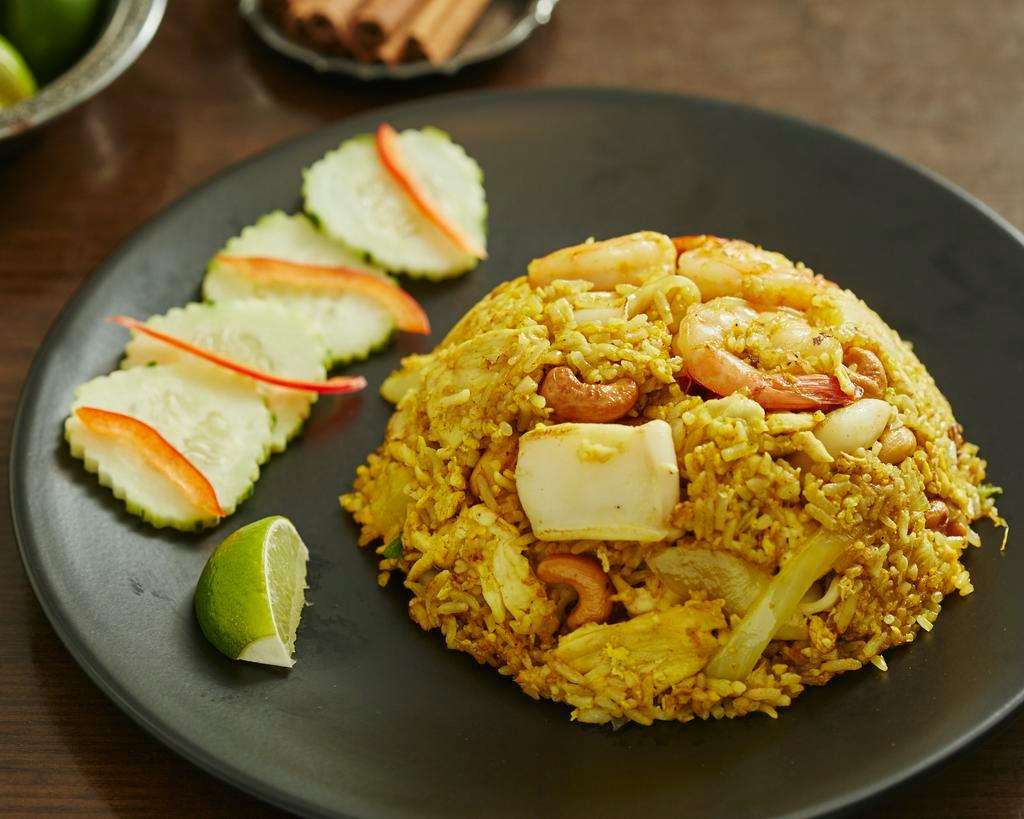Pineapple Fried Rice  · Chicken, shrimp and squid, with egg, onions, scallions & cashew nuts