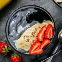 Charcoal Bowl · Base: Activated charcoal, Pineapple, Banana, Coconut milk
Toppings: Strawberry,  frozen yogu...