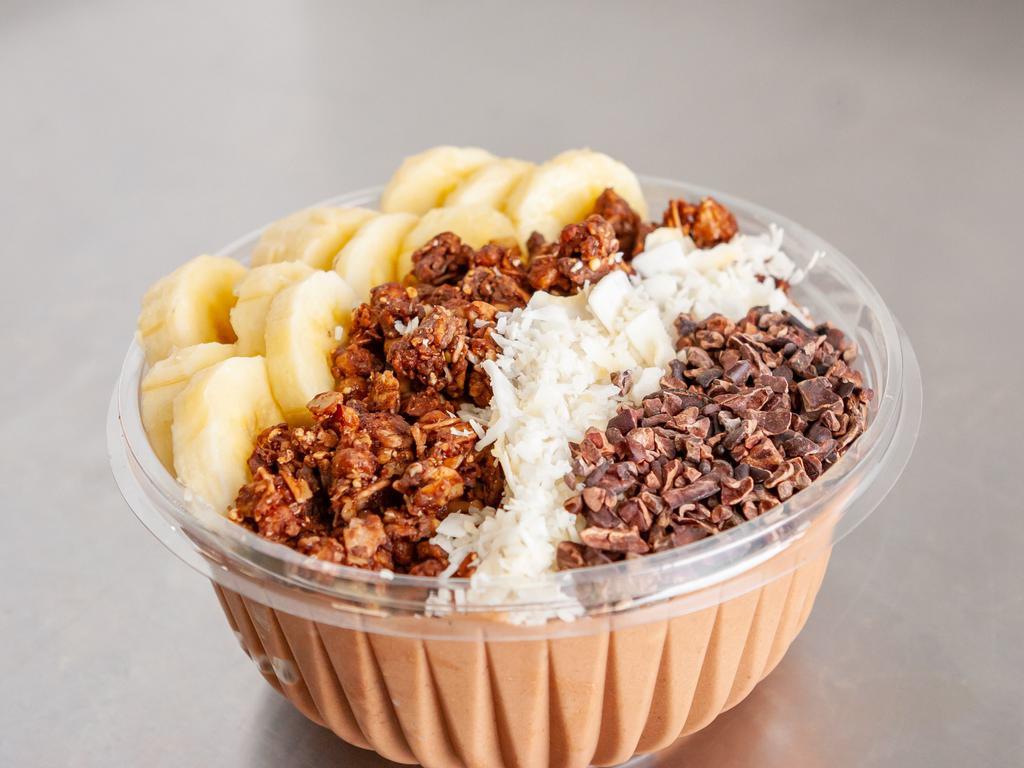Chocolate PB DELIGHT Bowl · Base: Organic Cacao, Peanut Butter, Banana, Organic Coconut milk
Toppings: Organic Cacao-Superfood Granola, Banana, Sliced Almonds, Shredded Coconut, Chocolate syrup.