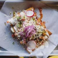 Taquitos Fritos · Fried tortilla rolls topped with salsa verde, queso fresco, pico de gallo, mixed greens, sal...