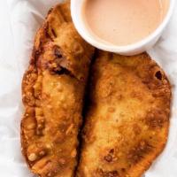 Spicy Smokey Chipotle Chicken with Cheese Empanadas · 2 flaky pastries filled with chicken and cheese, served with salsa verde and sweet chipotle ...