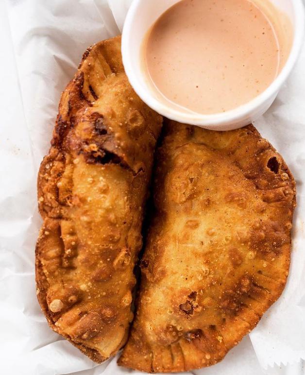 Spicy Smokey Chipotle Chicken with Cheese Empanadas · 2 flaky pastries filled with chicken and cheese, served with salsa verde and sweet chipotle aioli.