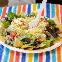 Taco Salad · Chips, mixed greens, cheese, beans, pico de gallo, sour cream and guacamole.