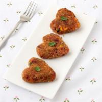 2  Vegetable Cutlet · Spicy deep-fried minced vegetable patties, served with chutney.