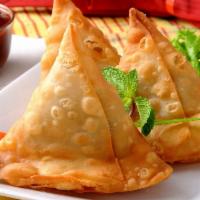 Vegetable Samosa · Crispy turnover, deliciously filled with mildly spiced potatoes and green peas.