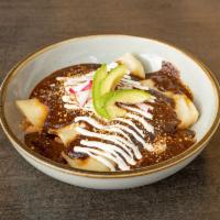 Enchiladas de Mole · 3 chicken and cheese enchiladas with crema fresca, cotija and fresco cheese.