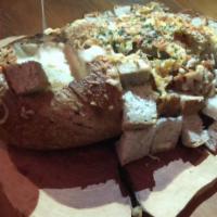 Pull Apart Bread · Bread stuffed with garlic butter and parmesan cheese filled with a cheese fondue cutout