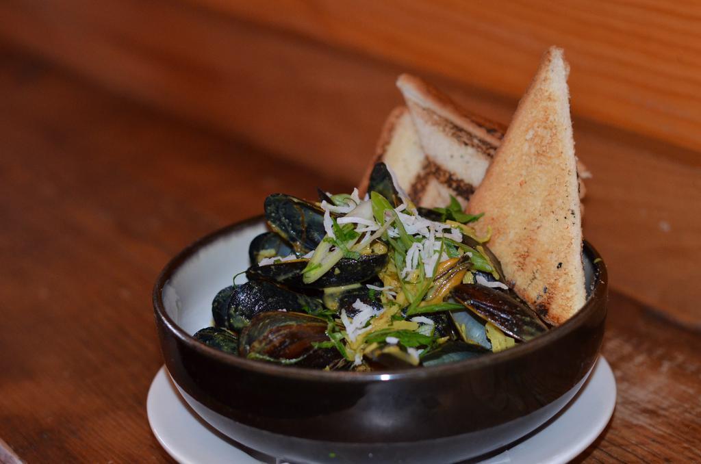 Coconut Curry Mussels · Caribbean curry spices, coconut milk slowly poached with the sweetness of mussels, come together. Completely Deliciousness....